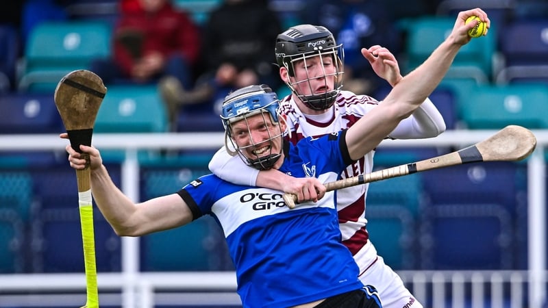 Cian Darcy of Sarsfields with possession of the sliotar as Ruairí Ó Mianáin looks to close him down