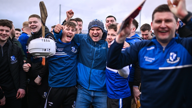 Sarsfields players and supporters celebrate after their side's victory over Slaughtneil