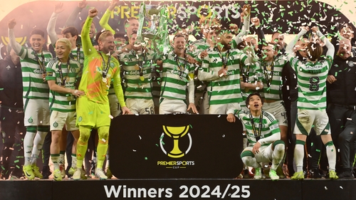 Celtic players celebrate as captain Callum McGregor lifts the Premier Sports Cup trophy