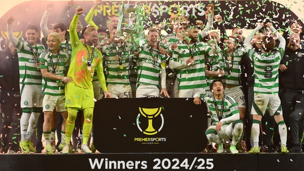 Celtic players celebrate as captain Callum McGregor lifts the Premier Sports Cup trophy