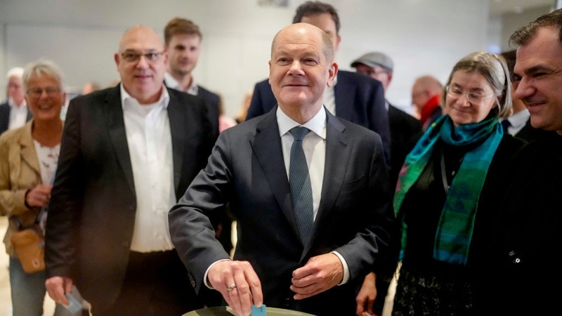 German Chancellor Olaf Scholz casts his ballot during a vote of confidence against himself