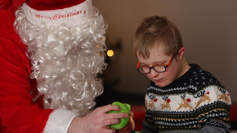 Santa chats with Tommy Donohoe during his visit to the grotto