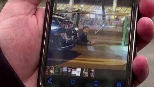 A person shows a video of the arrest of Taleb Jawad al-Abdulmohsen on his phone