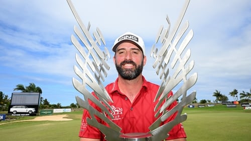 A triumphant John Parry poses with the trophy