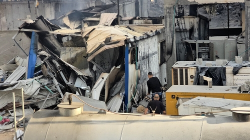 People check the damage outside the Kamal Adwan hospital in Beit Lahia, Gaza following Israeli strikes on 6 December