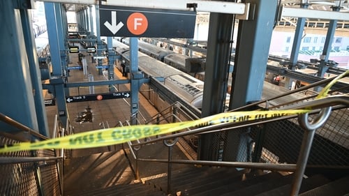 Police investigate at the Coney Island-Stillwell Avenue Station in New York City after a woman aboard a subway car was set on fire and died
