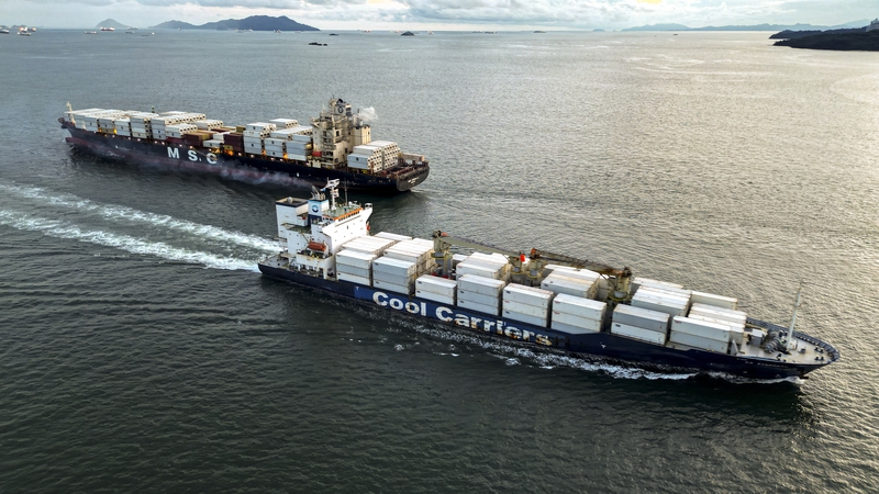 Two cargo ships pass each other during their entry and exit to the Panama Canal at the Pacific Ocean near Panama City