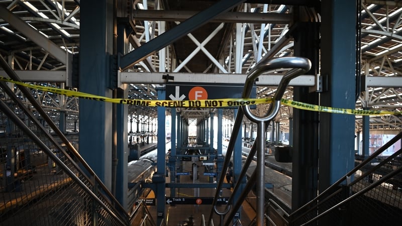 Police investigate at the Coney Island-Stillwell Avenue Station in Brooklyn after a woman aboard a subway car was set on fire and died in New York