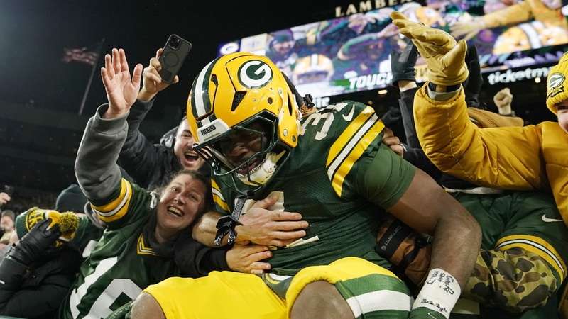 Green Bay's Emanuel Wilson celebrates with fans after extending his side's lead
