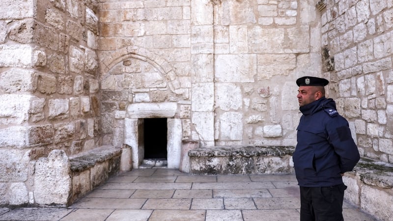 A Palestinian policeman stands guard outside the entrance of the Nativity Church Complex in Bethlehem