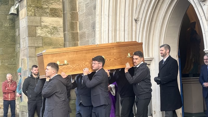 Gearóíd Ó Cairealláin's remains leaving St Peter's Cathedral in west Belfast