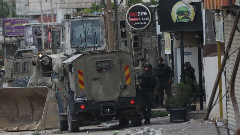 Israeli armored military vehicles patrol the streets of Tulkarem, West Bank during a raid