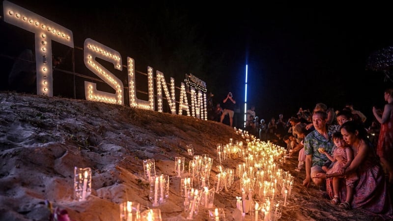 Mourners place candles on the beach at the Ban Nam Khem Tsunami Memorial Park in the southern Thai province of Phang Nga
