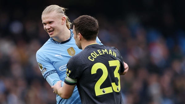 Erling Haaland shrugs off Seamus Coleman before taking his penalty