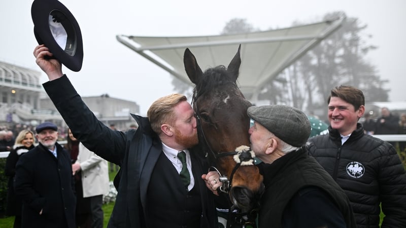 Owners Neil (L) and Con Sands kiss Solness after sending him out to win the Paddy's Rewards Club Steeplechase