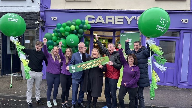 Owners and staff of Carey's Shop, Béal an Mhuirthead, Co Maigh Eo celebrate selling a winning Lotto ticket worth €5.4 million