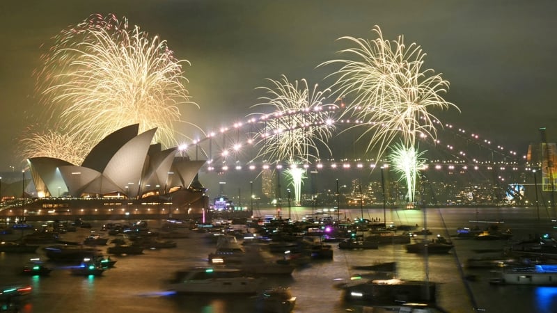 Fireworks light up the Opera House and the Sydney Harbour Bridge ahead of the main show at midnight