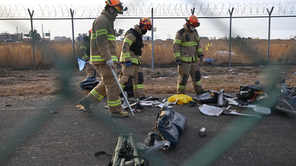 Recovery teams work at the crash scene at Muan International Airport
