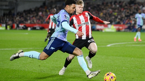 Ethan Nwaneri is challenged by Keane Lewis-Potter of Brentford