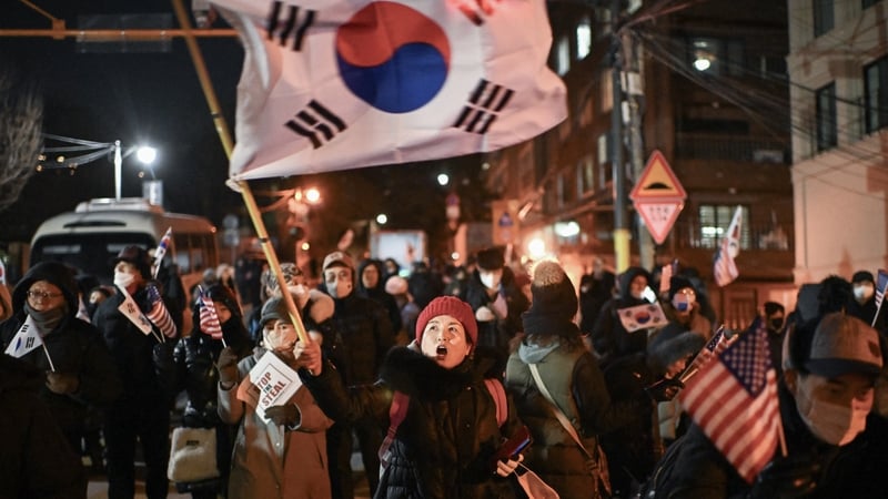A woman waves South Korea's flag during a rally to support impeached president Yoon Suk Yeol