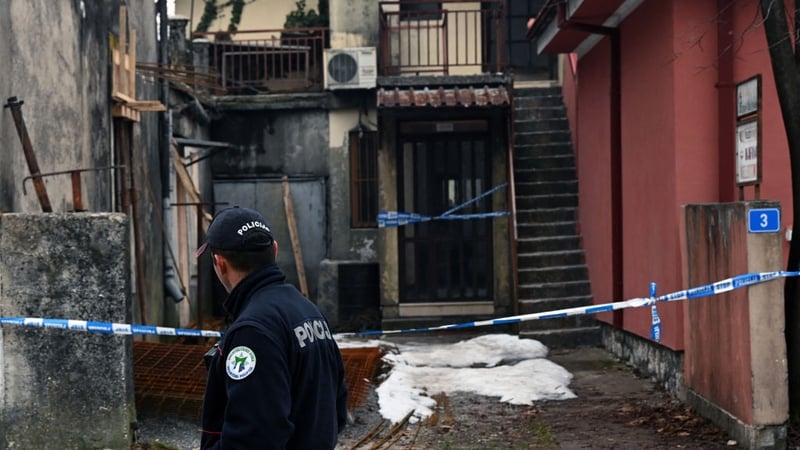 A police officer walks by the crime scene at the restaurant in Cetinje, Montenegro