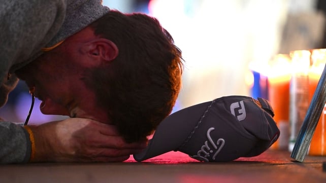 A man bows his head at a memorial on Bourbon Street, New Orleans, following a truck attack in which 15 people died in the early hours of New Year's day