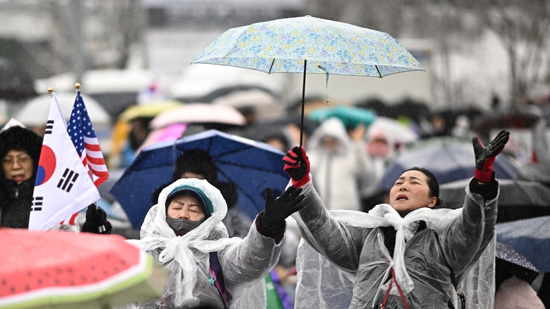 Supporters of impeached South Korea President Yoon Suk Yeol during a rally near his residence as snow falls in Seoul