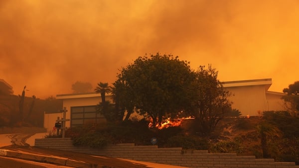 The fire is burning near homes in the Pacific Palisades area