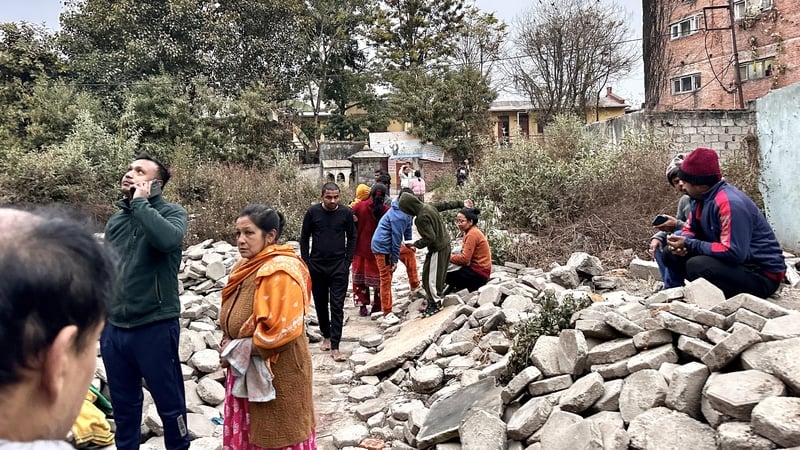 People gather in an open area following earthquake tremors in Kathmandu