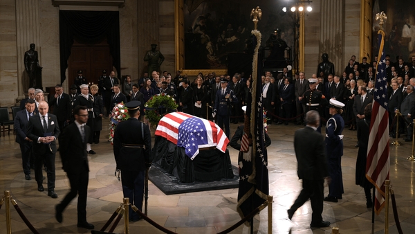 Guests pay their respects in front of the flag-draped casket at the Lying in State Ceremony for former President Jimmy Carter