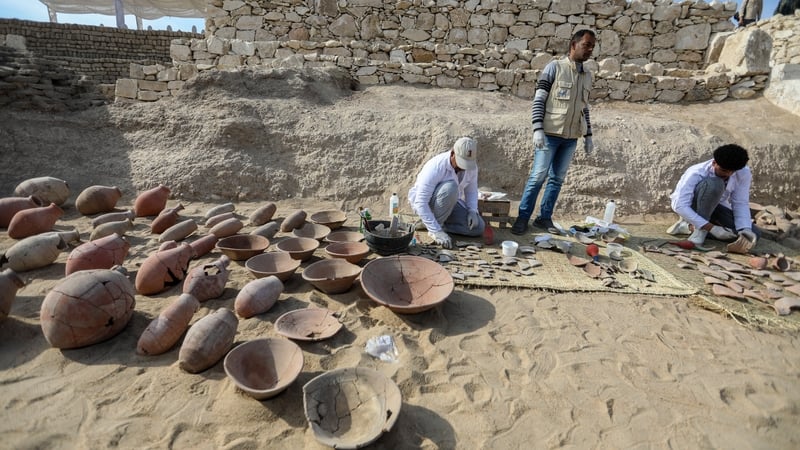 Archaeologists examine discovered and reassembled pottery fragments in an intact section of the foundations of Queen Hatshepsut's temple at Deir el-Bahari in Luxor