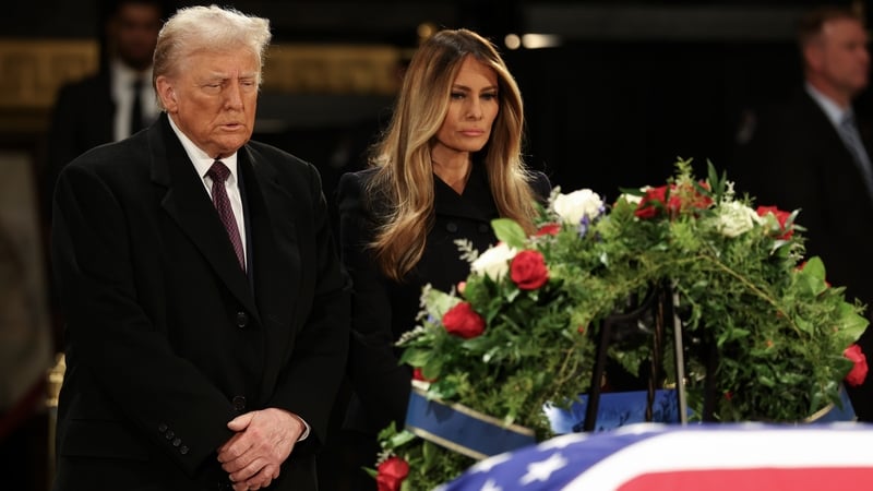 Donald Trump and his wife former first lady Melania Trump visit the flag-draped casket of former US president Jimmy Carter in the US Capitol Rotunda