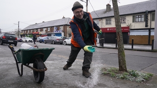 A Dublin City Council worker grits a footpath in Ballygall