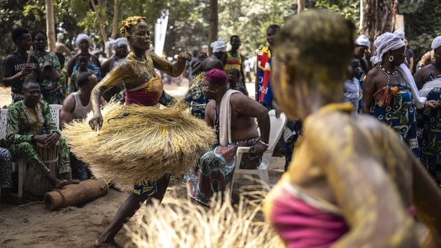 A Kokou initiate, a warrior god in the traditional religion of Benin, dances in the sacred forest in Ouidah during the first day of the Voodoo Festival
