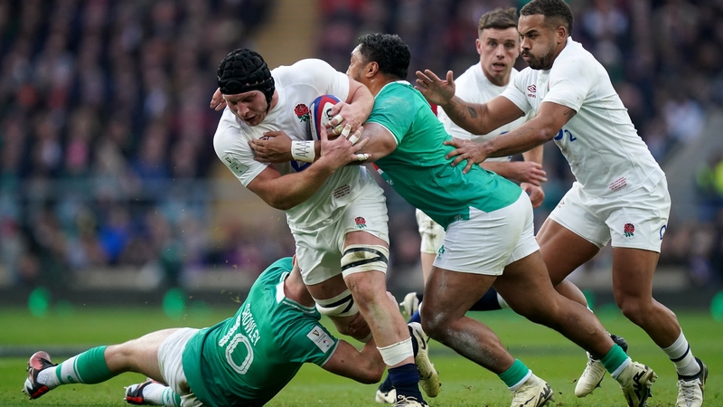 England's Sam Underhill being tackled by Ireland's Jack Crowley (L) and Bundee Aki during the 2024 Six Nations
