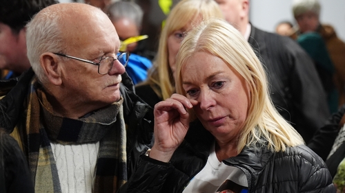 Sharon, the mother of John George, returns with family members to Belfast Airport