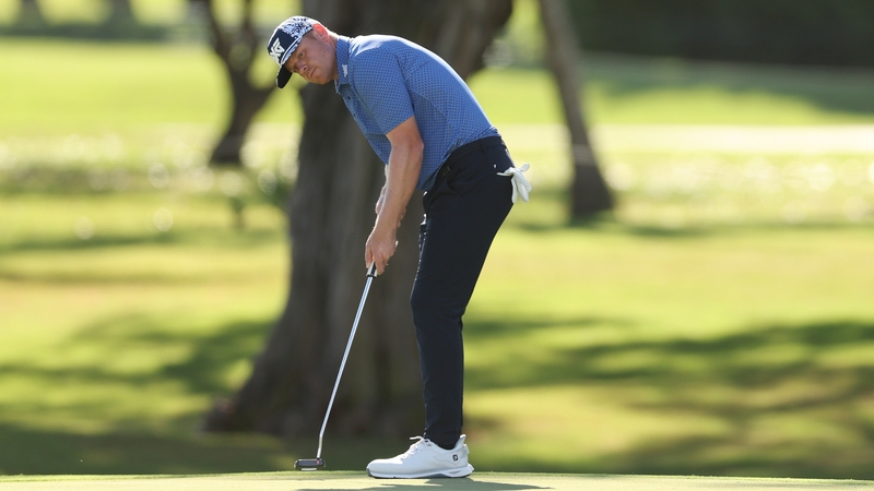 Patrick Fishburn putts on the fourth green