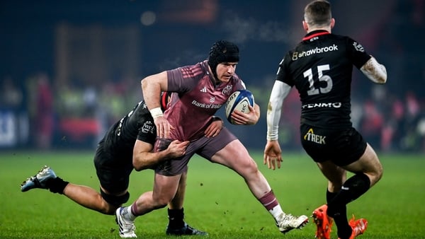 Rory Scannell of Munster is tackled by Juan Martin Gonzalez