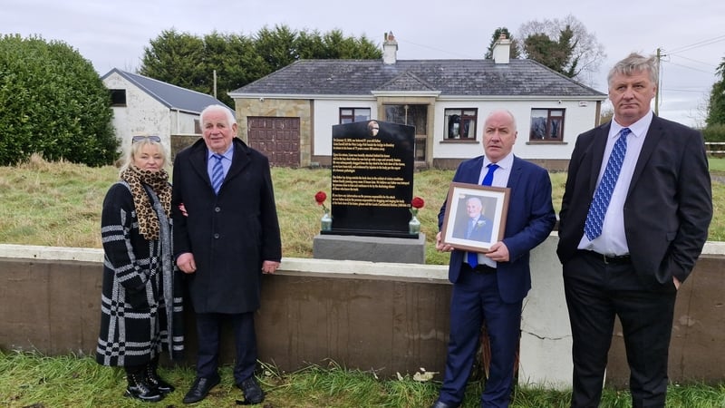 The family of Liam Farrell pictured with an image of him outside his home