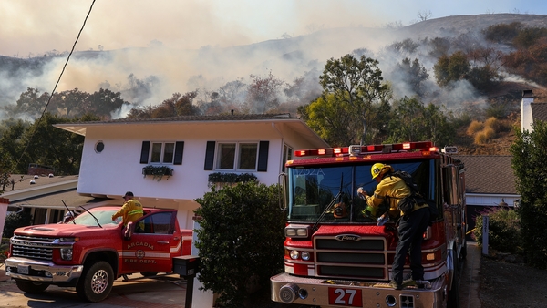 Firefighters work to contain the Palisades Fire near the Brentwood neighbourhood in Los Angeles