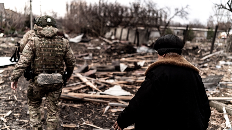 Soldiers and a civilian walk among damaged structures as civilians were evacuated from Pokrovsk, Ukraine, early this year