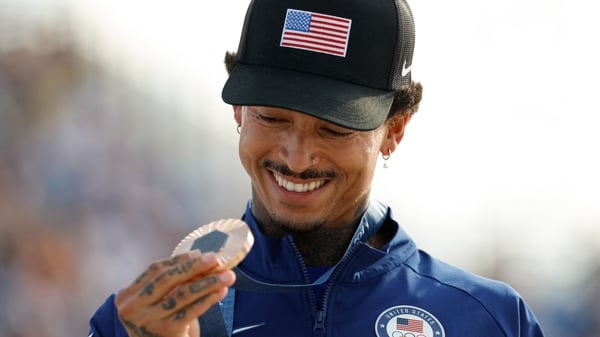 Skateboarder Nyjah Huston with his bronze medal on the podium; he has since complained about its quality