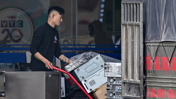 A man transports equipment removed from VTC, Vietnam's second-most popular TV station
