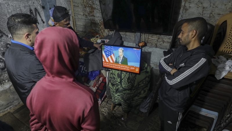 Residents of the Bureij camp, central Gaza watch updates on the ceasefire deal together