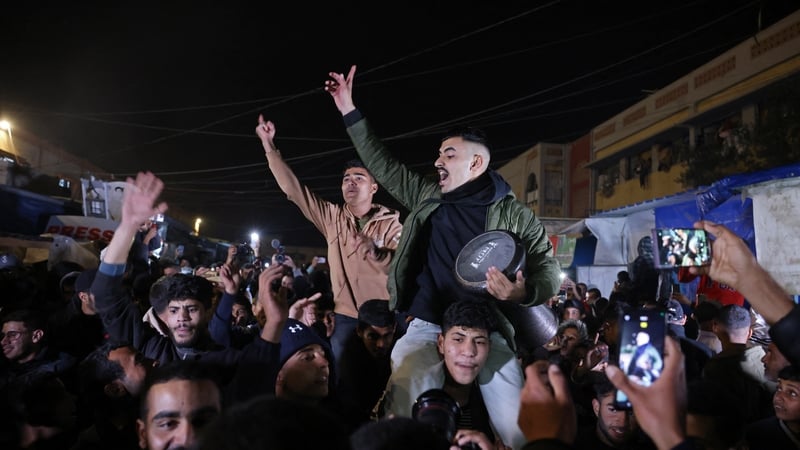 People celebrate along a street in Khan Yunis in southern Gaza on January 15, 2025 (Getty Images)
