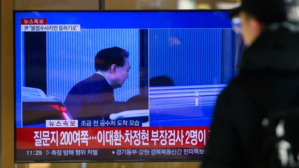 A news broadcast with shows South Korean impeached President Yoon Suk Yeol arriving at the Corruption Investigation Office for High-ranking Officials