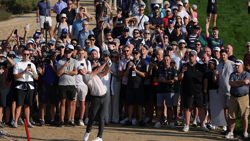 Large crowds watch Rory McIlroy play his third shot on the 14th hole