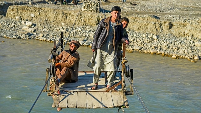 People use a zipline to cross the Kokcha river at Yaftal Sufla district in Badakhshan province, Afghanistan