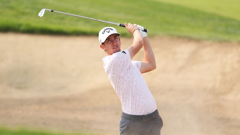 Tom McKibbin plays out from the bunker at the second hole