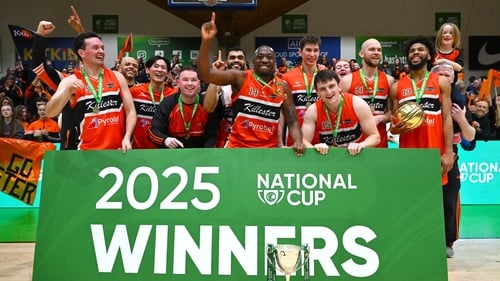 Killester players celebrate with the Pat Duffy Cup after their side's victory